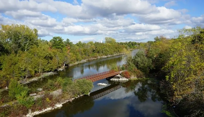 Calm river beside a paved riverside trail