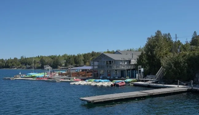 Kayaks stacked at a lake marina dock