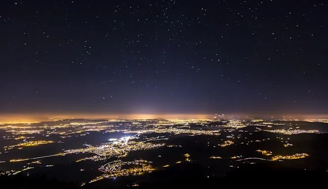 Mountain ridges above a valley town at dusk